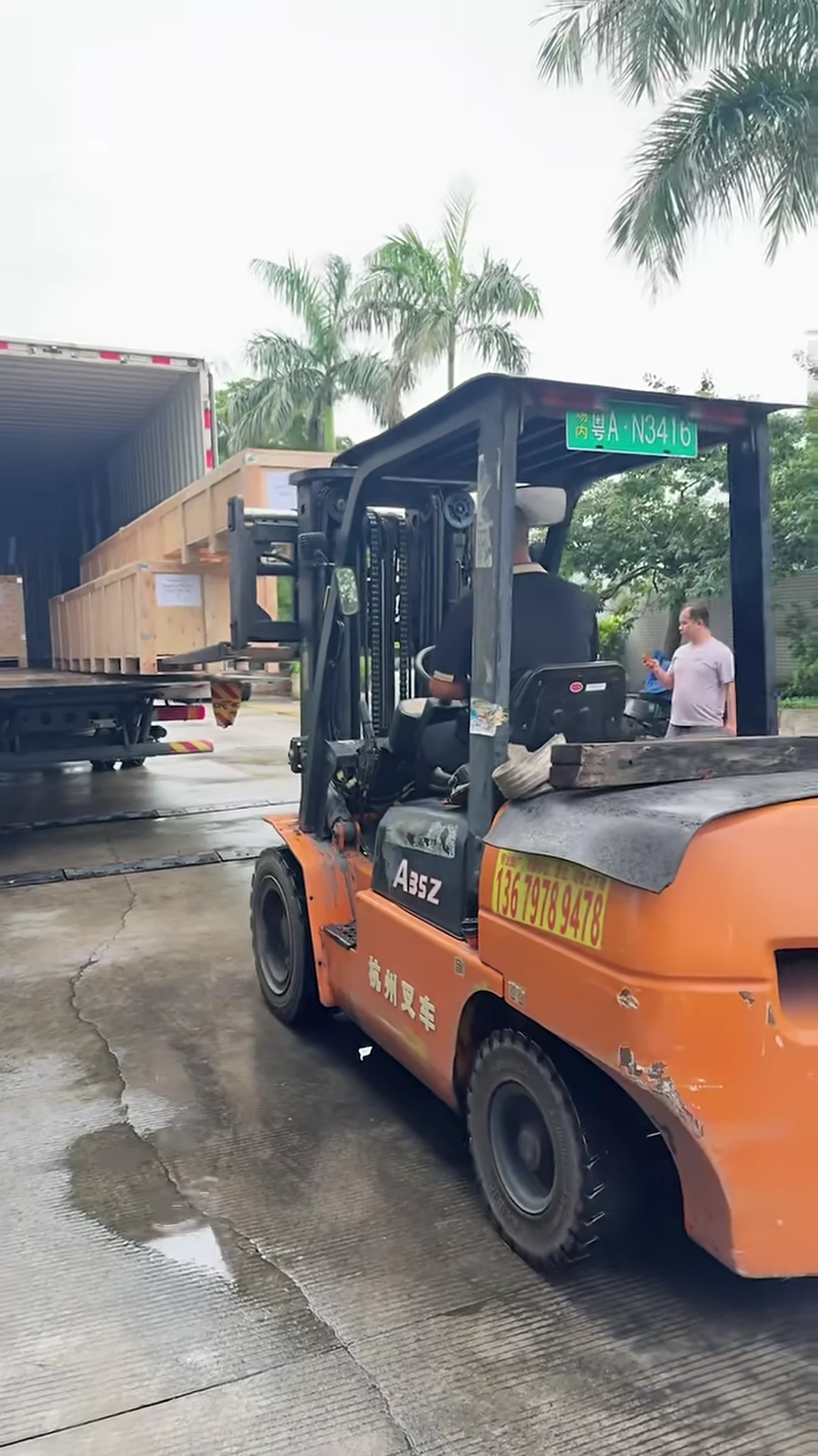 Forklift loading timber pergola crates into an export container